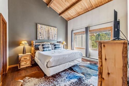 a bedroom with a bed and a television in it at Rocky Mountain Mama in Breckenridge