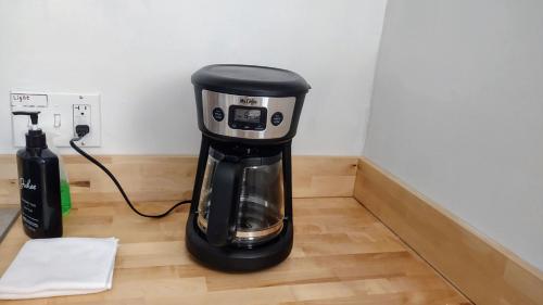 a coffee maker sitting on top of a wooden floor at Entire House in Twinsburg in Twinsburg