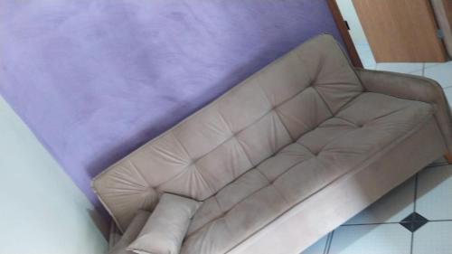 a brown leather couch sitting in a living room at Casa da ilse in Foz do Iguaçu