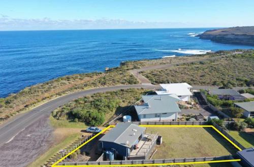 an aerial view of a house next to the ocean at Ocean View Getaway in Port Campbell