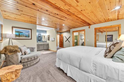 a bedroom with a large bed and a wooden ceiling at Tahoe Retreat with Scenic Views and Spacious Deck in Tahoe Vista