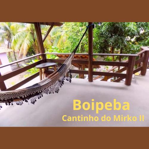a hammock on a porch of a resort at Boipeba Cantinho do Mirko II in Ilha de Boipeba