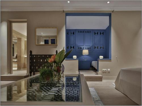 a living room with a blue door and a table at Villa in Ibiza with Cala Moli Beach Access in Valdepeñas