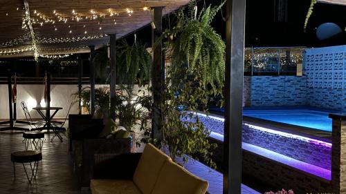 a patio with a swimming pool at night at Apolonia Boutique in Guaduas