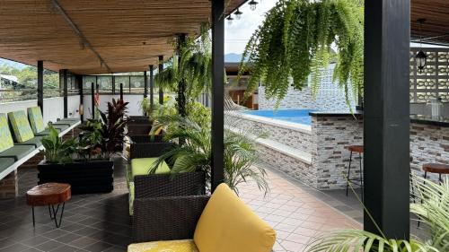 an outdoor patio with plants and a swimming pool at Apolonia Boutique in Guaduas