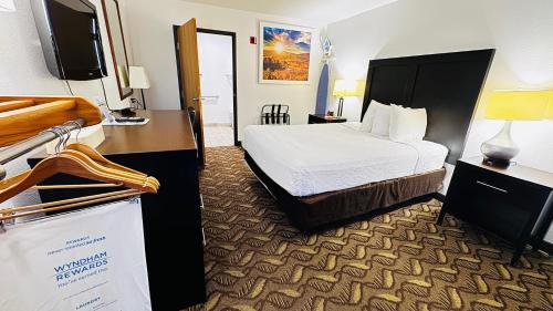 a hotel room with a bed and a television at Days Inn by Wyndham North Platte in North Platte