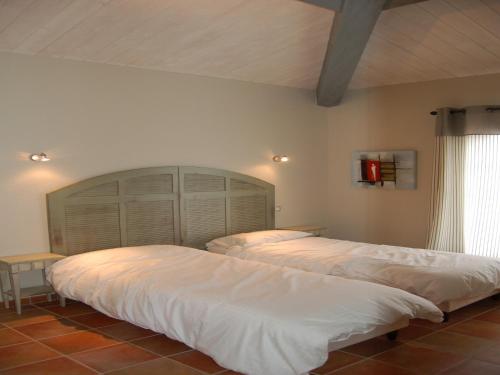 une chambre avec deux lits et une grande tête de lit dans l'établissement Villa in Callian with Private Pool, à Callian