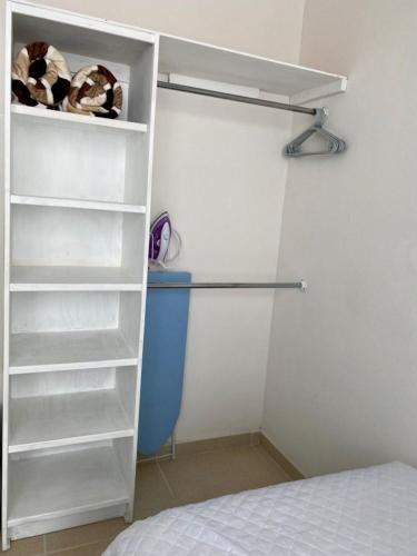 a white closet with shelves and a bed at CASABONITA fte alberca, AirAc in Alpuyeca