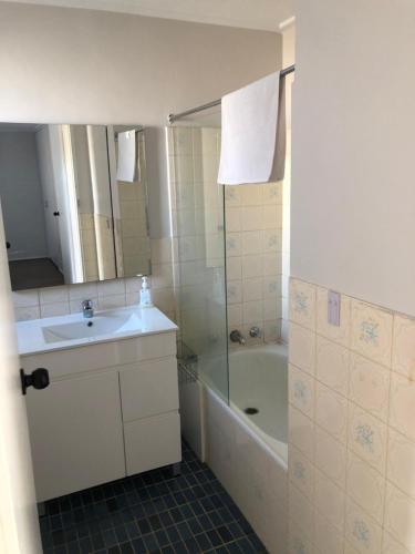 a bathroom with a sink and a shower and a tub at Home Away From Home in Melbourne