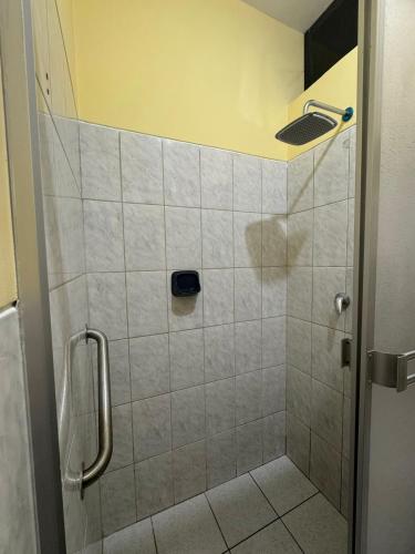 a bathroom with a shower with a tiled shower at Kovakii Hotel in Tarapoto