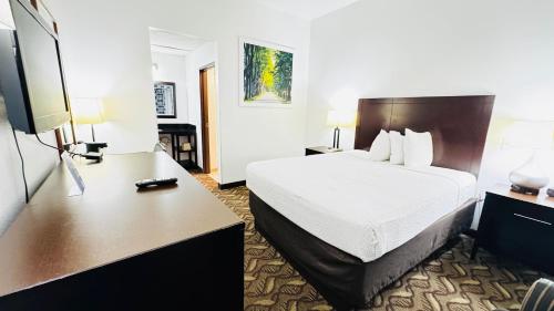 a hotel room with a bed and a desk at Days Inn by Wyndham North Platte in North Platte