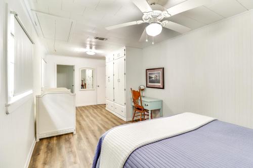 a bedroom with a bed and a ceiling fan at River Frontage Quiet Mississippi Vacation Rental in McComb