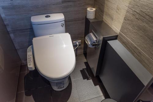 a bathroom with a white toilet in a stall at Taipei Discover Hostel in Taipei