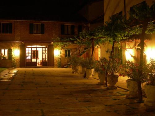 a courtyard at night with potted plants and lights at Tenuta Terensano in Monleale