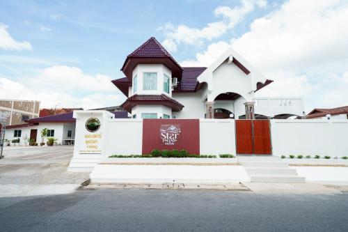 a white house with a red and white fence at The Star Pool Villa Hatyai in Hat Yai