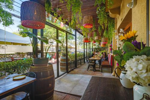a restaurant with a bunch of plants and flowers at Tagle Hotel Boutique in Santiago