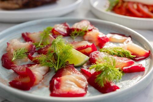 a bowl of strawberries and a lemon on a table at Townhouse Hotel in Wagga Wagga