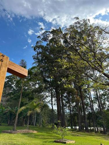 a wooden cross in a field with trees in the background at The Escape Home in Repton