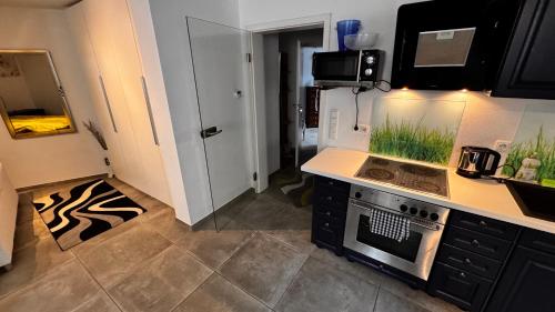 a kitchen with a stove and a counter top at nice Apartment in Schwarzenbruck