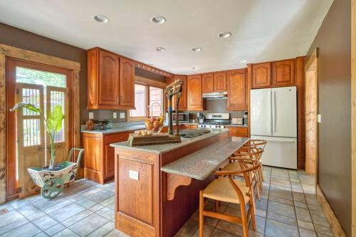 a kitchen with wooden cabinets and a large island at The Lodge at Highland Farms in Brightwood