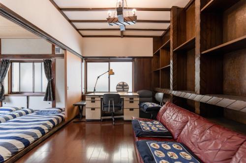 a room with bunk beds and a desk at Osaka Kanzakigawa Royal駅徒步1分 "private house 3 bed rooms "一棟貸し宿 in Osaka