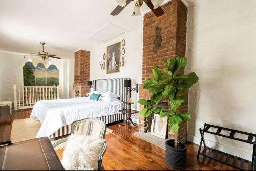 a bedroom with a bed and a brick wall at Chic Cottage near the Lower French Quarter in New Orleans