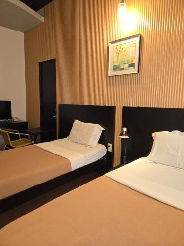 Ένα ή περισσότερα κρεβάτια σε δωμάτιο στο First Pacific Inn Davao