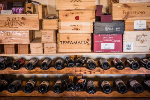 a bunch of wine bottles on display in a store at Agriturismo Il Tiro in Castel del Piano
