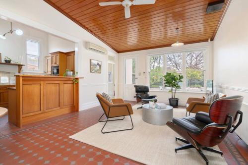 a living room with chairs and a table at Bellisle - 1880's period home in Central Albury in Albury
