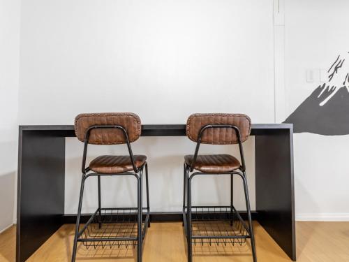 two bar stools sitting in front of a counter at Tabist Hotel Kippaku in Takamatsu