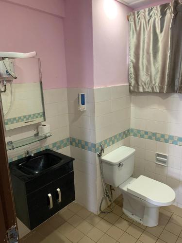 a bathroom with a toilet and a sink and a mirror at ZNZ Oasis Homestay in Port Dickson
