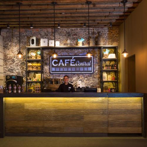 a man standing behind the counter of a bar at Historico Central Hotel in Mexico City