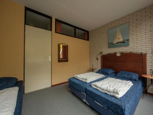 a bedroom with two beds and a table and a door at Luxe Glamping Getaway in Bruinisse
