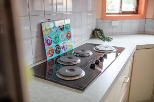 a stove top oven in a kitchen next to a counter at Family Beach House Near Barwon River & Beaches in Barwon Heads