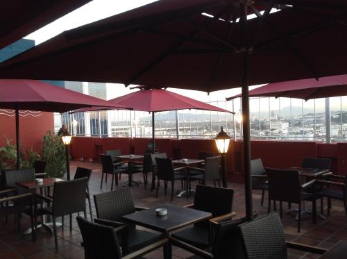 a restaurant with tables and chairs and umbrellas at El Hana International in Tunis