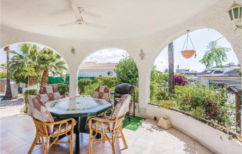 a dining room with a table and chairs on a patio at Urb San Luis in Torrevieja