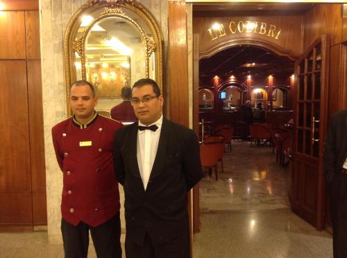two men standing next to each other in a restaurant at El Hana International in Tunis