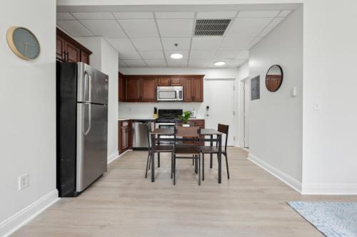 a kitchen and dining room with a table and chairs at East 225 I Modern Studio In Downtown Rochester in Rochester