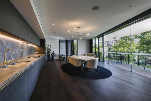 an open kitchen and dining room with a table and chairs at Kangaroo Point Apartment by Urban Rest in Brisbane
