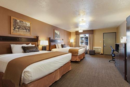 a hotel room with two beds and a television at Best Western PLUS Ruby's Inn in Bryce Canyon