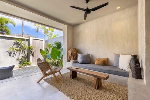 a living room with a couch and a chair at The Konkret Lombok in Kuta Lombok