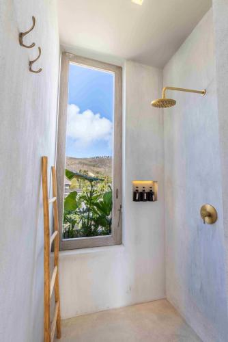 a bathroom with a window with a view at The Konkret Lombok in Kuta Lombok
