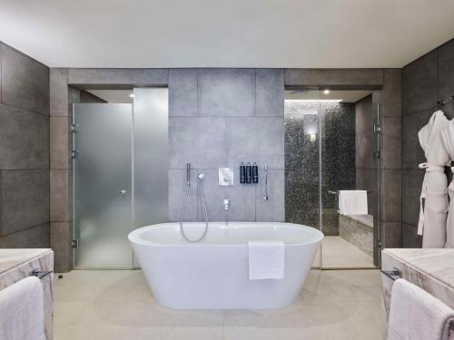 a large bathroom with a tub and a shower at Hilton Cairo Nile Maadi in Cairo