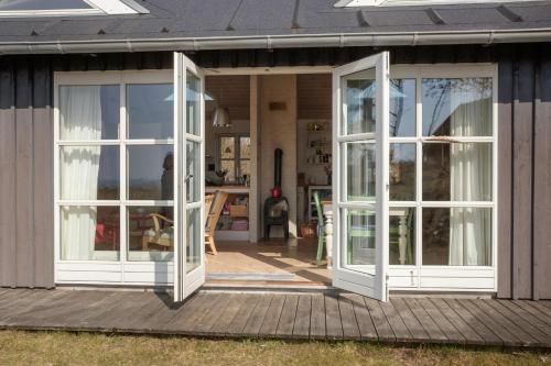 two french doors on a house with a porch at Awesome Home In Knebel With 2 Bedrooms And Wifi in Knebel