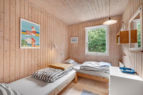 une chambre avec deux lits et un bureau dans l'établissement Well-Maintained Vacation Home Close To A Lovely Bathing Beach, à Ebeltoft