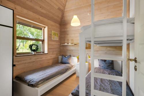 a bedroom with bunk beds in a tiny house at Beautiful And Family-Friendly Holiday Home For 9 People With A Spa Bath Near Grenaa Beach in Grenå