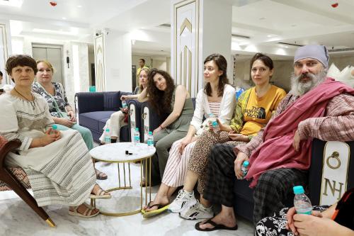 a group of people sitting in a room at Hotel Namaste Hindustan Just a Minute Away From New Delhi Railway Station and Connaught place in New Delhi