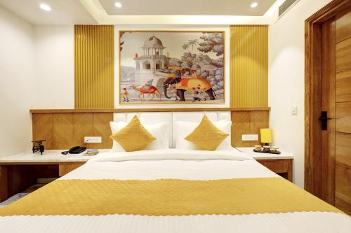 a bedroom with a bed and a painting on the wall at Hotel Namaste Hindustan Just a Minute Away From New Delhi Railway Station and Connaught place in New Delhi