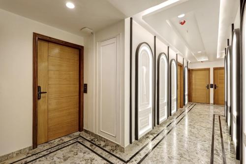 a hallway with wooden doors and a tile floor at Hotel Namaste Hindustan Just a Minute Away From New Delhi Railway Station and Connaught place in New Delhi