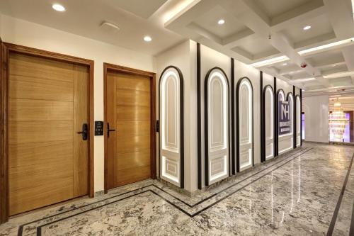 a hallway with wooden doors in a building at Hotel Namaste Hindustan Just a Minute Away From New Delhi Railway Station and Connaught place in New Delhi